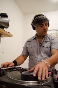 a man wearing headphones is playing a dj turntable